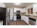 Renovated kitchen featuring white cabinets, granite counters, and stainless steel appliances at 2648 Cavalier Dr, Decatur, GA 30034