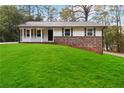 Charming ranch home with white siding and green lawn at 117 Neal Ave, Stockbridge, GA 30281