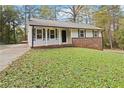 Recently updated ranch home with white exterior and a well manicured lawn at 117 Neal Ave, Stockbridge, GA 30281