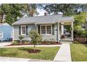 Charming gray house with a well-manicured lawn and walkway at 1257 Lyle Nw Pl, Atlanta, GA 30318