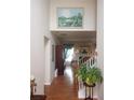 Bright entryway with hardwood floors, staircase, and large painting at 102 Ozark Trl, Canton, GA 30114