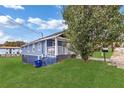 Side view of a blue house with a porch, lawn, and a recycling bin at 406 Elm Nw St, Atlanta, GA 30314