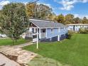 Front view of a blue house with a porch and a for sale sign at 406 Elm Nw St, Atlanta, GA 30314