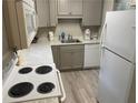 Galley kitchen with white appliances and gray cabinets at 5311 Waits Se Dr, Mableton, GA 30126