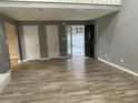 Open living room with gray walls, wood-look floors, and access to the front door at 5391 Kelleys Mill Circle, Stone Mountain, GA 30088