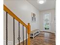 Bright foyer with hardwood floors, bench and staircase at 3333 Castleberry Village Cir, Cumming, GA 30040