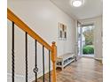 Inviting entryway with wood-look floors, bench, and access to the backyard at 3333 Castleberry Village Cir, Cumming, GA 30040