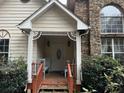 Small front porch with wooden railing and light blue chairs at 2520 Conley Dr, Cumming, GA 30040