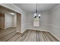 Bright dining room with new flooring and a modern light fixture at 245 Southmoor Cir, Stockbridge, GA 30281