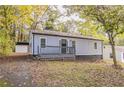House exterior showcasing gray siding, a deck, and a detached garage at 1790 Ledo Ave, Decatur, GA 30035