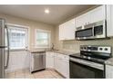 Modern kitchen featuring white cabinets, granite countertops, and stainless steel appliances at 1790 Ledo Ave, Decatur, GA 30035