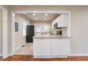 Modern kitchen with white cabinets, granite countertops, and stainless steel appliances at 1790 Ledo Ave, Decatur, GA 30035