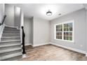 Finished basement room with wood-look flooring and large window at 114 Arborwood Way, Temple, GA 30179