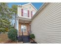 Two-story townhome featuring a brick and vinyl exterior, and a covered front porch at 810 Abbotts Mill Ct # 83, Duluth, GA 30097