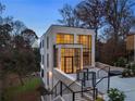 Elevated view of a modern brick home with large windows and a patio at 247 Huntington Ne Rd, Atlanta, GA 30309