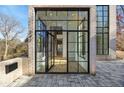 Modern black-framed glass front door of a brick home, showing the entryway at 247 Huntington Ne Rd, Atlanta, GA 30309