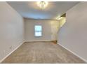 Spacious living room with neutral carpeting and natural light at 6043 Heisler St, Rex, GA 30273