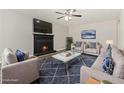 Virtually staged living room with fireplace and modern furnishings at 5595 Deerfield Trl, Atlanta, GA 30349