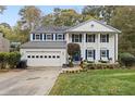 Two story house with white siding, blue shutters, and a landscaped front yard at 1055 Cranberry Crk, Roswell, GA 30076