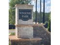 Winsome Park community entrance sign with brick pillars at 111 Winsome Way, Woodstock, GA 30188