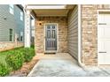 Front entry with a dark door and brick facade at 11711 Brightside Pkwy, Hampton, GA 30228