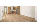 Spacious kitchen with light wood cabinets, stainless steel appliances, and hardwood floors at 1180 Lupo Loop, Chattahoochee Hills, GA 30268