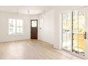 Light and airy living room featuring hardwood floors and sliding glass doors at 1180 Lupo Loop, Chattahoochee Hills, GA 30268