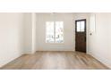 Bright living room with hardwood floors and large windows at 1180 Lupo Loop, Chattahoochee Hills, GA 30268