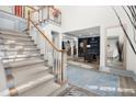 Elegant staircase with light beige carpeting and gray railings at 2680 Spalding Dr, Sandy Springs, GA 30350