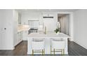 Modern white kitchen with marble island and breakfast bar at 3630 Peachtree Ne Rd # 3106, Atlanta, GA 30326