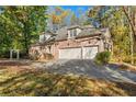 Brick house exterior with three-car garage at 100 Charleston Cir, Roswell, GA 30076