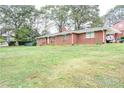 Brick ranch house with a spacious lawn at 680 Sherwood Dr, Jonesboro, GA 30236