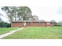 Brick ranch house with a spacious lawn at 680 Sherwood Dr, Jonesboro, GA 30236