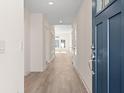 Light and bright entryway with luxury vinyl plank flooring and a navy blue front door at 1326 Cedarcrest Blvd, Acworth, GA 30101