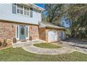 Brick front of house with a double garage and a blue front door at 2958 Applewood Ne Ct, Atlanta, GA 30345