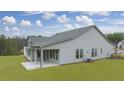 Rear view of a gray house with a covered patio and backyard at 3759 Tielman St, Snellville, GA 30078