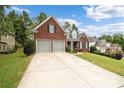 Brick home with a two car garage and well-kept lawn at 143 Templeton Ln, Villa Rica, GA 30180