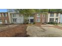 Brick front of townhome with small yard and parking at 5595 Marbut Rd, Lithonia, GA 30058