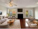 Virtually staged living room with fireplace and hardwood floors at 3781 Harvest Dr, Decatur, GA 30034