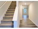 Staircase with carpet runner leading to the second floor at 36 Earle Dr, Cartersville, GA 30121