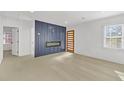 Light and airy living room with a modern fireplace and hardwood floors at 2067 Arlington Nw Cir, Atlanta, GA 30318