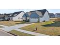 Blue craftsman home with a white two-car garage and a large front yard at 20 Black Rock Rdg, Sharpsburg, GA 30277