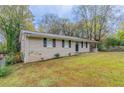 Brick ranch house with a driveway and landscaped yard at 3851 Bonnie Se Ln, Atlanta, GA 30354