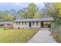 Brick ranch house with a driveway and landscaped yard at 3851 Bonnie Se Ln, Atlanta, GA 30354