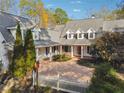 Two story home with white exterior, grey roof and a wrap around porch at 220 Spring Branch Dr, Canton, GA 30115