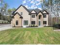 Luxury two-story home with stone and brick facade at 1540 Brooks S Rd, Lawrenceville, GA 30045