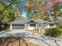 Ranch home with white siding, black garage door, and landscaping at 513 Duke Dr, Marietta, GA 30066