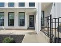 Modern townhouse entrance with black metal fence and dark door at 124 Pearl St, Woodstock, GA 30188