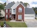 Two story brick home with a landscaped yard at 2000 Spicers Ln, Woodstock, GA 30189