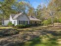 Charming one-story home with white siding, green shutters, and a front porch at 1765 Holly Springs Ne Rd, Marietta, GA 30062